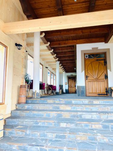 a porch with blue stairs and a wooden door at Willa na Borku in Ciche