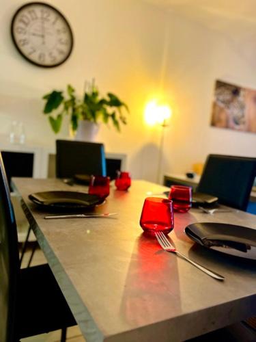 a long table with chairs and a clock on the wall at Malibu Village T2 in Canet-en-Roussillon