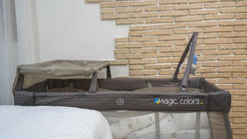 a toolbox sitting on a bed next to a brick wall at Apartamento ruh sara by Toledo AP in Toledo