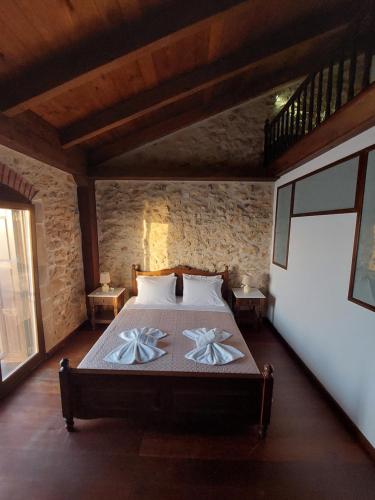 a bedroom with a bed with flowers on it at Volakas Beachfront Suites in Rethymno