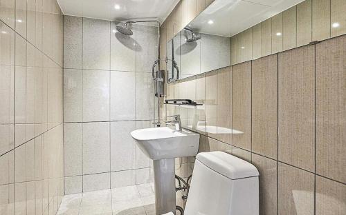 a bathroom with a toilet and a sink at Hotel WO Yongsan Station in Seoul