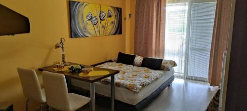 a living room with a couch and a dining room table at Slnečné apartmány in Podhájska