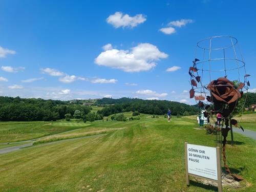 a sign with a view of a golf course at Golf Resort Klöch in Klöch
