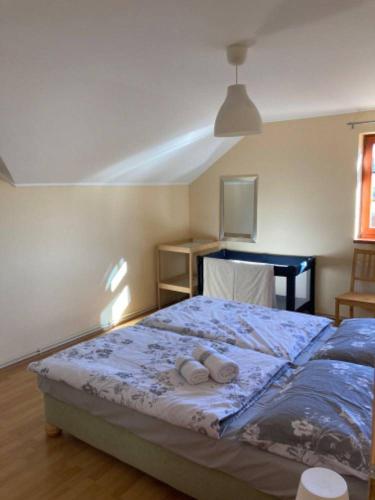 a bedroom with a bed with two towels on it at Apartmány Kamermann in Hroznětín