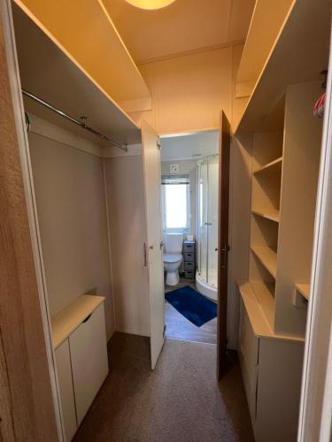 a bathroom with a sink and a toilet in a room at Lodge Caravan on Holiday Park in Chichester