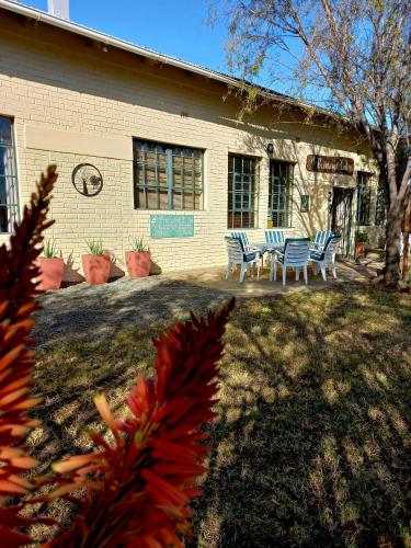 a building with chairs and a table in front of it at Brentwood Lodge in Denysville