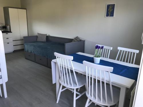 a room with a table and chairs and a bed at Solhem Bohus Björkö in Björkö