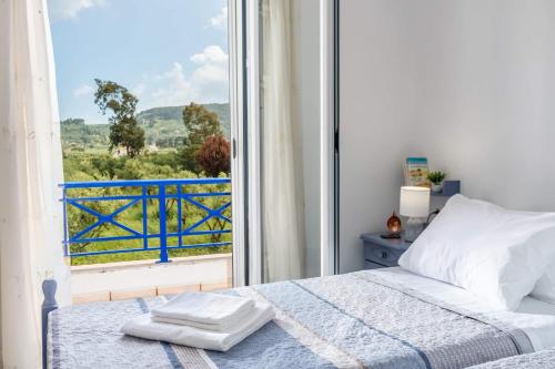 a bedroom with a bed and a large window at Tsilivi Blue Vista Apartment in Tsilivi
