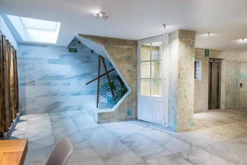 un couloir avec un escalier dans une maison avec une porte dans l'établissement Hotel Vacanzy Urban Boutique Adults Only, à Corralejo