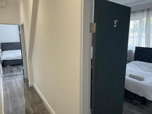 a room with a bedroom with a bed and a mirror at Zams rooms in Stoke on Trent