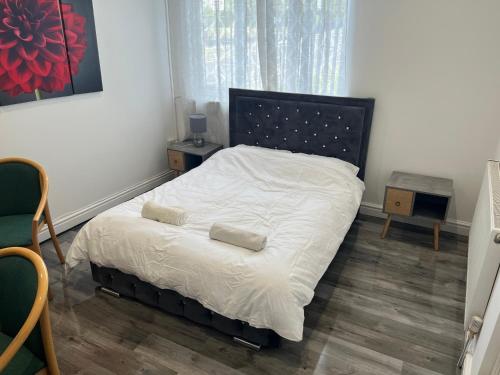 a bedroom with a bed with two pillows on it at Zams rooms in Stoke on Trent