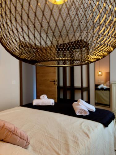 a bedroom with a bed with two towels on it at La Casa OM in Almorox