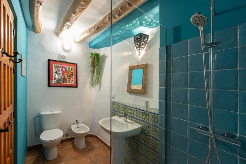 a bathroom with a toilet a sink and a mirror at Atelier 88 Boutique B&B in Alcalá la Real