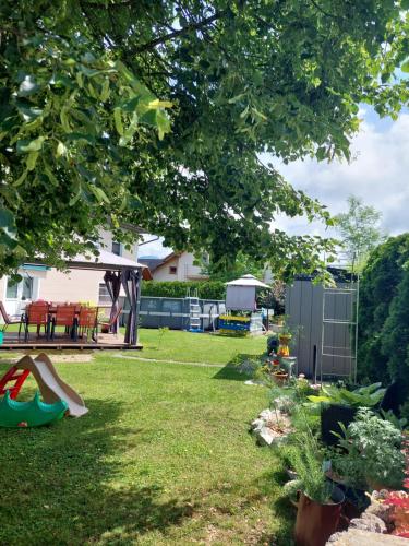 a yard with a playground and a house at Studio apartma Žirovnik in Cerklje na Gorenjskem