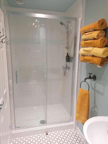 a shower with a glass door in a bathroom at No 30 Guest House, Aberdare in Aberdare