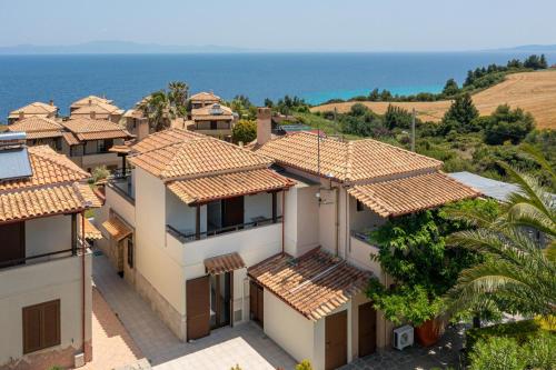 an aerial view of a house with the ocean in the background at Afitos Hidden Gems #FeelsLikeHome in Afitos