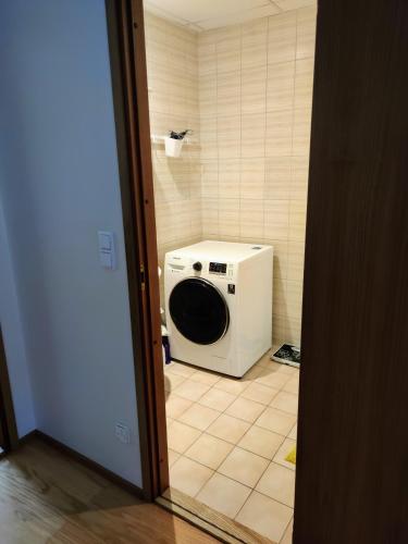 a washing machine sitting in the corner of a bathroom at Central 3 bedroom apartment in Kuressaare in Kuressaare