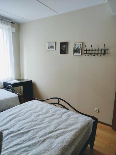 a bedroom with a bed and pictures on the wall at Central 3 bedroom apartment in Kuressaare in Kuressaare