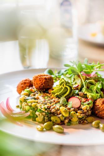 a white plate with a salad with different foods at Nordsee-Hotel Arlau-Schleuse in Husum