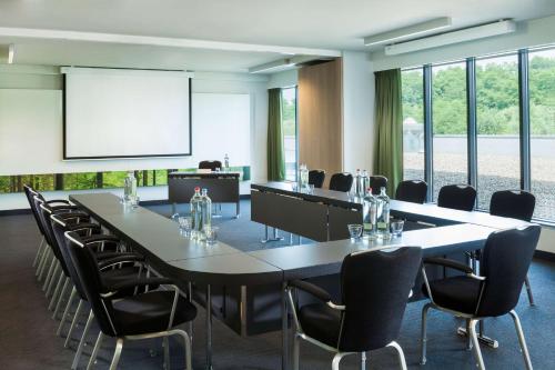 a conference room with a large table and chairs at Park Inn by Radisson Liege Airport in Liège