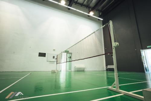 a tennis court with a net in a room at Serene Heights by Evernent in Miri