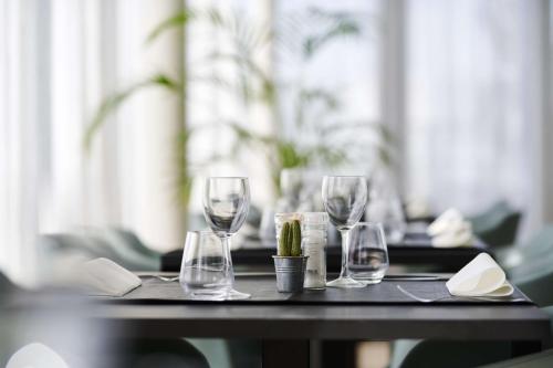 a table with three wine glasses on top of it at Park Inn by Radisson Liege Airport in Liège