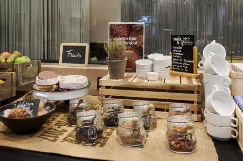 a table with many jars of food on it at Park Inn by Radisson Liege Airport in Liège