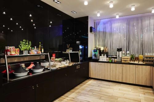 a restaurant with a counter with pots and pans at Park Inn by Radisson Liege Airport in Liège