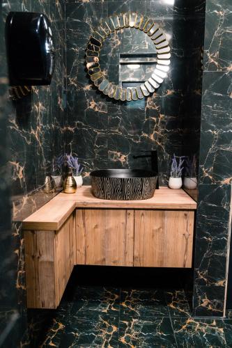 a bathroom with a sink and a mirror at Vila GRANDE MAMAIA NORD in Mamaia Sat/Năvodari