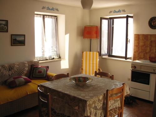 a living room with a table and a couch at Holiday home Maso Mersi in Castello Tesino