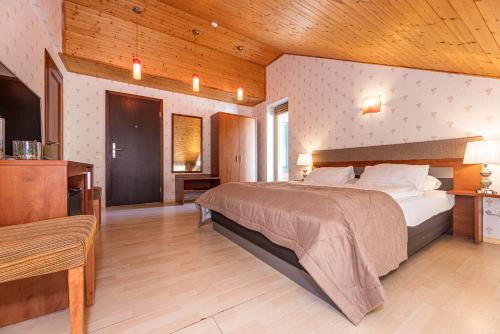 A bed or beds in a room at Palanga Park Hotel
