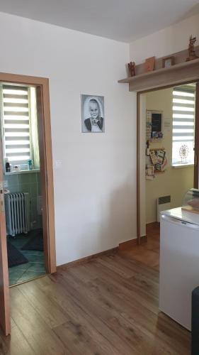 a living room with a white wall and two windows at Apartman BibKa in Donovaly