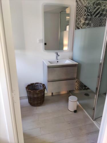 a bathroom with a sink and a mirror at Lodge 2 étoiles la tête dans les pins les pieds dans l eau in Lacanau