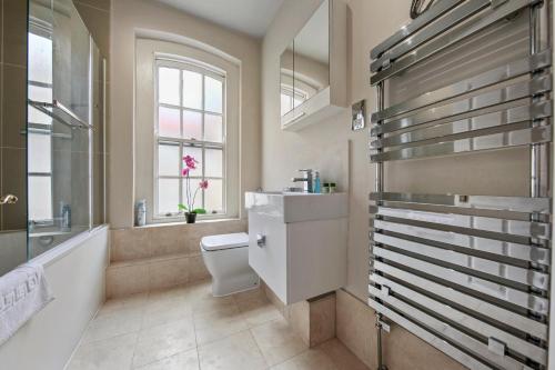 a bathroom with a tub and a toilet and a sink at 1 Bed Executive Apartment near Liverpool Street Station FREE WIFI by City Stay Aparts London in London