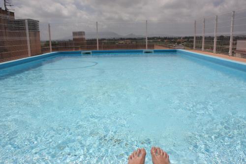 a person laying in a large swimming pool at Lo Petit Delta in El Lligallo del Gànguil