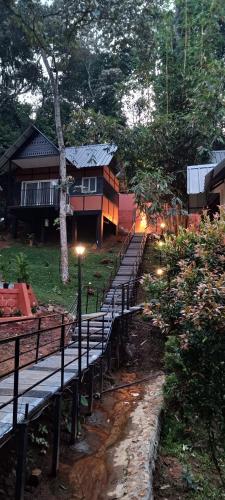 a row of benches in front of a house at Santhi Hill View Resort in Munnar