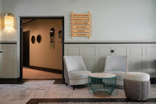 two chairs and a table in a lobby at Grand Hôtel Bristol in Colmar
