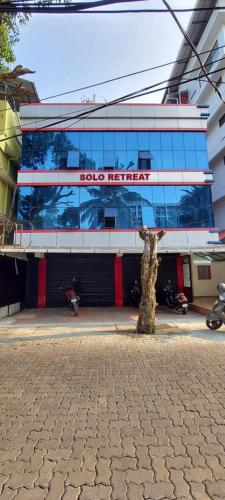a building with a sign on the side of it at The Solo Retreat in Ernakulam