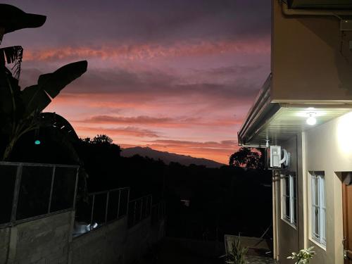 a sunset from the balcony of a house at Patterville Transient House in Iba