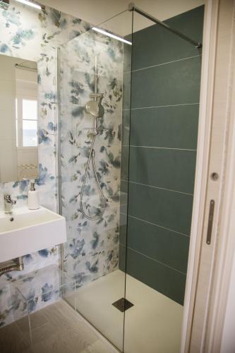 a shower with a glass door next to a sink at B&B L'ORIZZONTE in Crotone