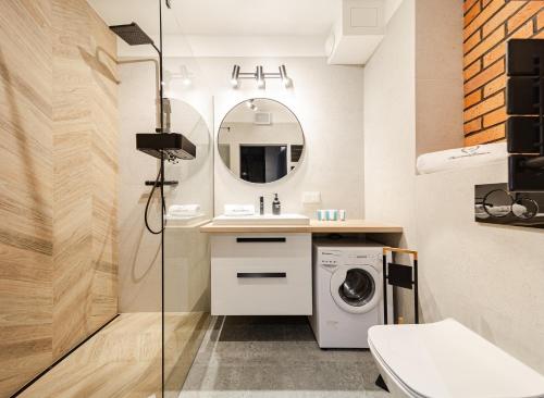 a bathroom with a washing machine and a sink at Apartamenty Gdansk EU - Dwie Motławy - OLD TOWN in Gdańsk
