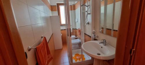 a small bathroom with a sink and a shower at Casa Marco in Praia a Mare