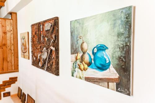a room with two paintings on a wall at Boutique Hotel Verdzi in Kutaisi