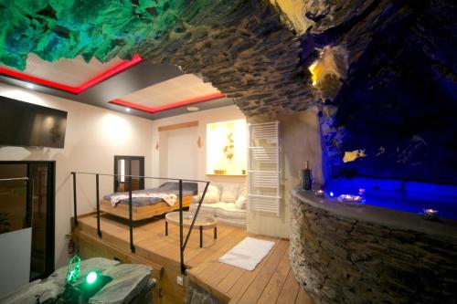 a living room with a large aquarium in the wall at The Ginkgo Collioure : Amazing Private Jacuzzi built in Rock, 20m from the Beach, A/C, WiFi, Patio... in Collioure