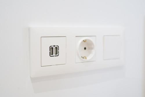a white electrical outlet with two plugs at Apartamentos La Jasa in Arguedas