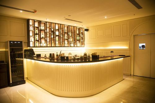 a lobby with a bar in a building at Hotel Jagadish International-Sankey Road in Bengaluru