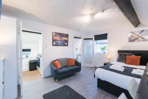 a bedroom with a bed and a chair at DD Apartment 10 - Free Parking - Fast WiFi in Castle Donington