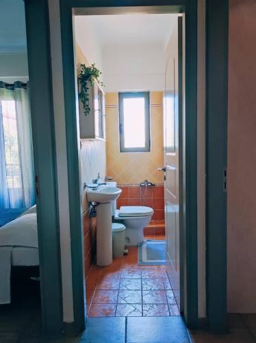 a bathroom with a sink and a toilet in a room at Nefeli City Apartments in Patra