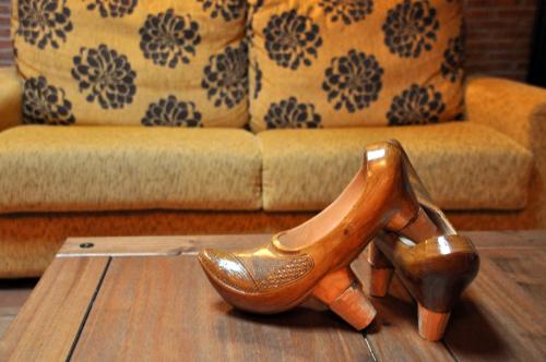 une paire de chaussures sur une table devant un canapé dans l'établissement Casa TINUCA, à Cos