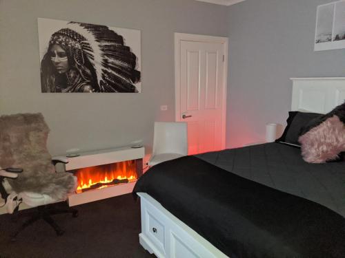 a bedroom with a bed and a fire place at Country Luxury in Scarsdale